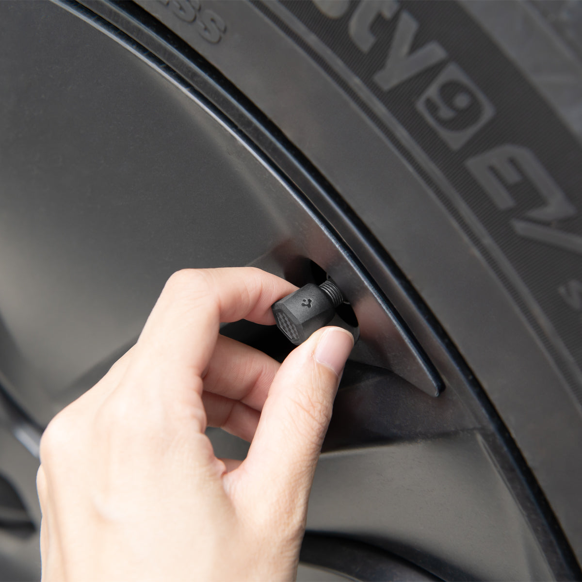 ACP09331 - Tesla Series Valve Stem Cover VS100 showing hand to control product