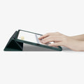 ACS07759 - iPad Pro 11-inch (2024) Case Urban Fit in Midnight Green showing the partial front with a hand typing on the device with a folded front cover propped up as a stand