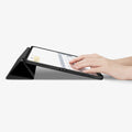 ACS07010 - iPad Pro 12.9-inch Case Urban Fit in Black showing the partial front with a hand typing on the device with a folded front cover propped up as a stand