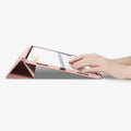 ACS07011 - iPad Pro 12.9-inch Case Urban Fit in Rose Gold showing the partial front with a hand typing on the device with a folded front cover propped up as a stand