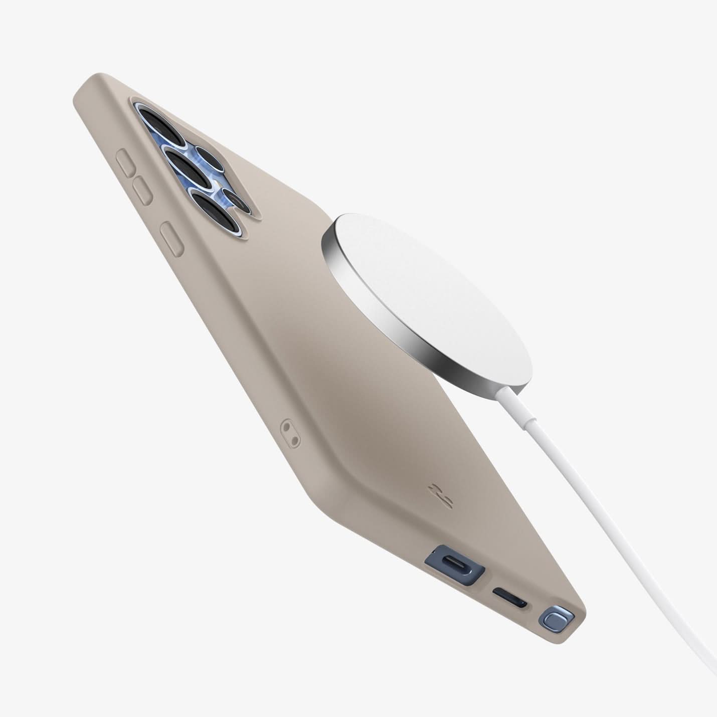 ACS09165 - Galaxy S25 Ultra Case Silicone Fit (MagFit + Qi2 Ready) in Natural Titanium showing the back of the magsafe charger hovering above the back of the device with the case on showing partial side and bottom