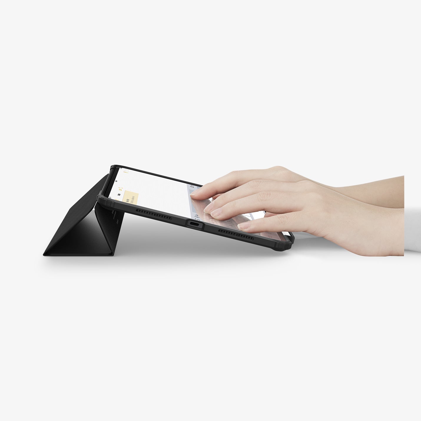 ACS07016 - iPad Pro 11-inch Case Ultra Hybrid Pro in Black showing the partial front with a hand typing on the device with a folded front cover propped up as a stand