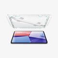 AGL07793 - iPad Pro 12.9-inch GLAS.tR EZ FIT in Clear showing the alignment tray with screen protector hovering above the device in landscape position