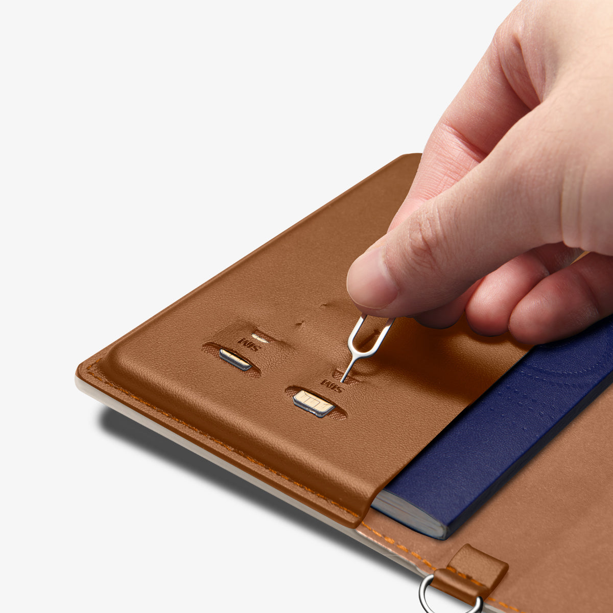 AFA08348 - Passport Holder in dune beige showing the inner with sim slots, taking out the pin ejector to remove the sim cards inserted