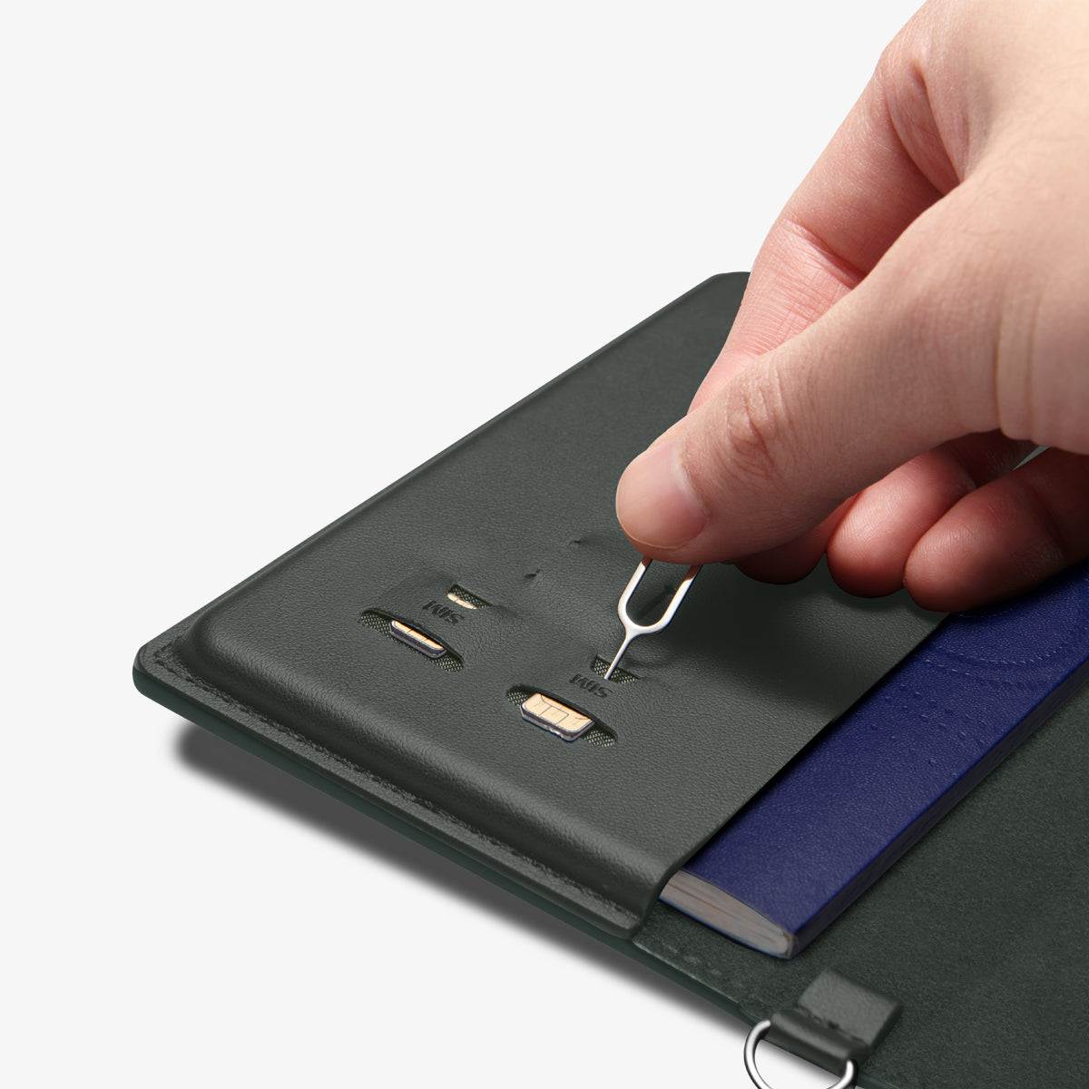 AFA08347 - Passport Holder in military green showing the inner with sim slots, taking out the pin ejector to remove the sim cards inserted
