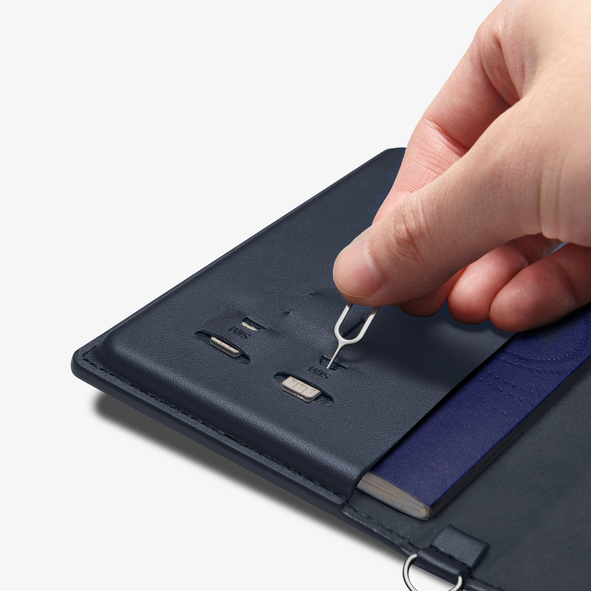 AFA08721 - Passport Holder in Navy Blue showing the inner with sim slots, taking out the pin ejector to remove the sim cards inserted