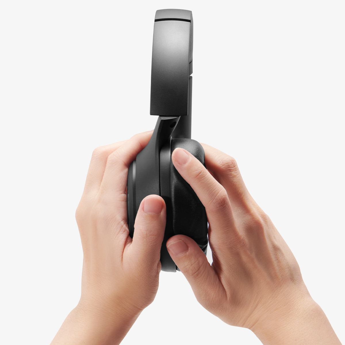 ASD09691 - Spigen Active Noise Cancelling SA2403 in Black showing the a person holding the ear cup
