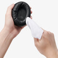 ASD09691 - Spigen Active Noise Cancelling SA2403 in Black showing a person cleaning the outer of the ear cup