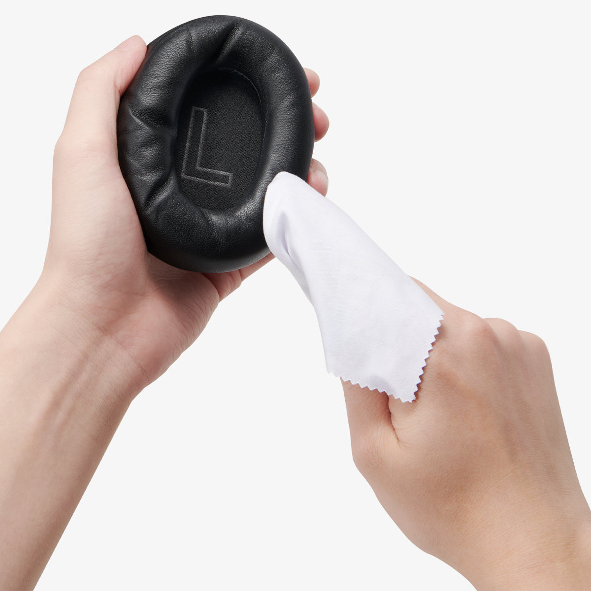 ASD09691 - Spigen Active Noise Cancelling SA2403 in Black showing a person cleaning the outer of the ear cup