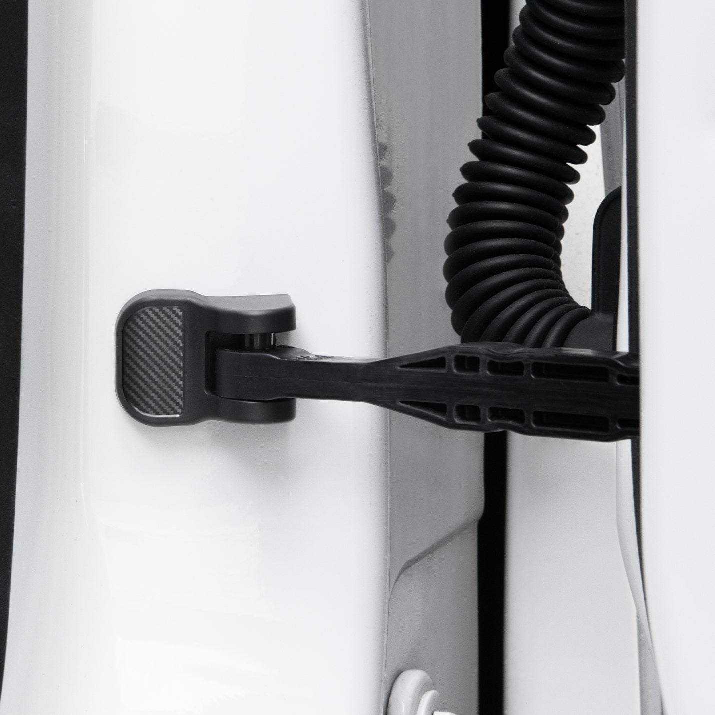 ACP07123 - Tesla Model Y & 3 Door Lock Cover TO320 in Black showing the door cover attached to the door striker hook