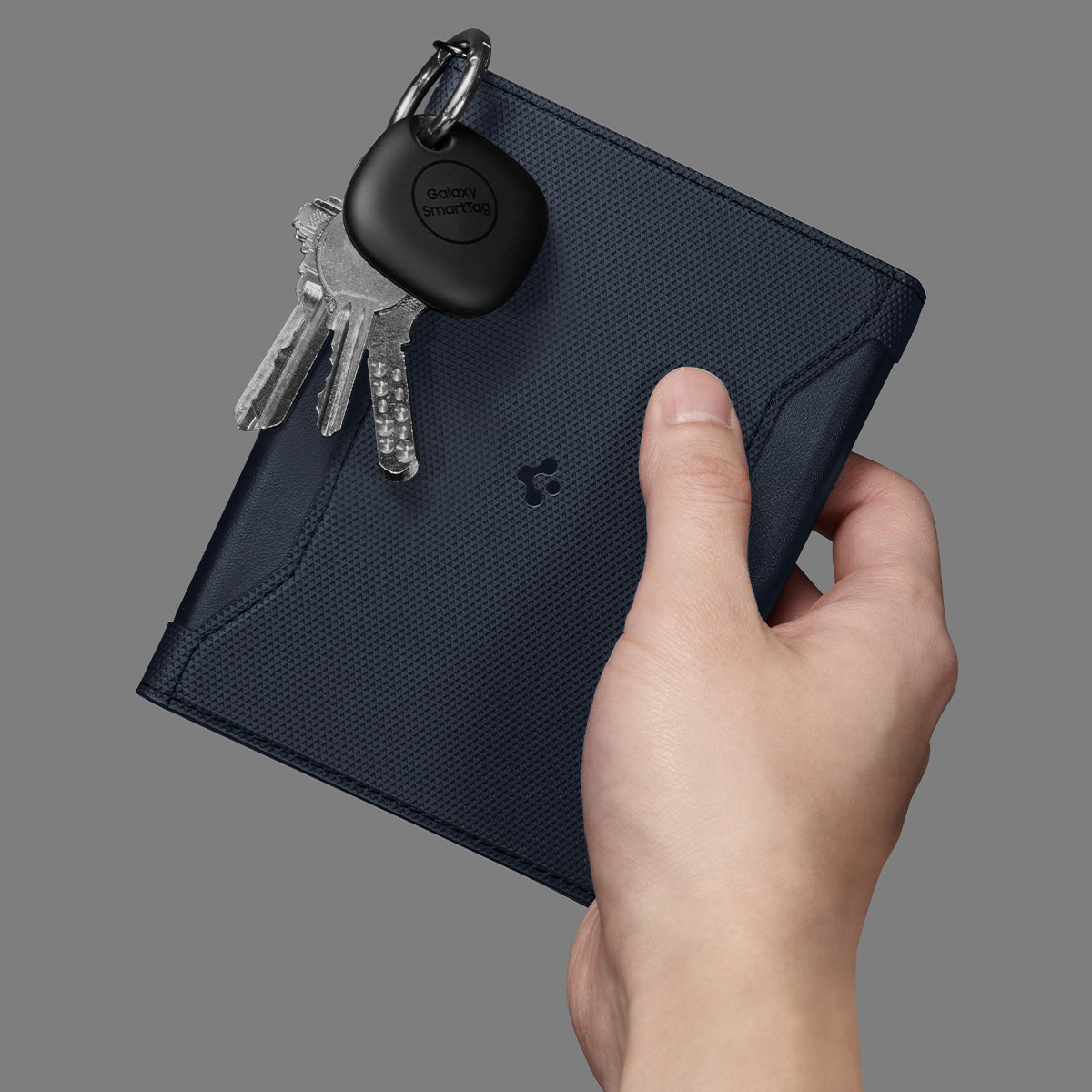 AFA08721 - Passport Holder in Navy Blue showing the front with carabiner attached for keys