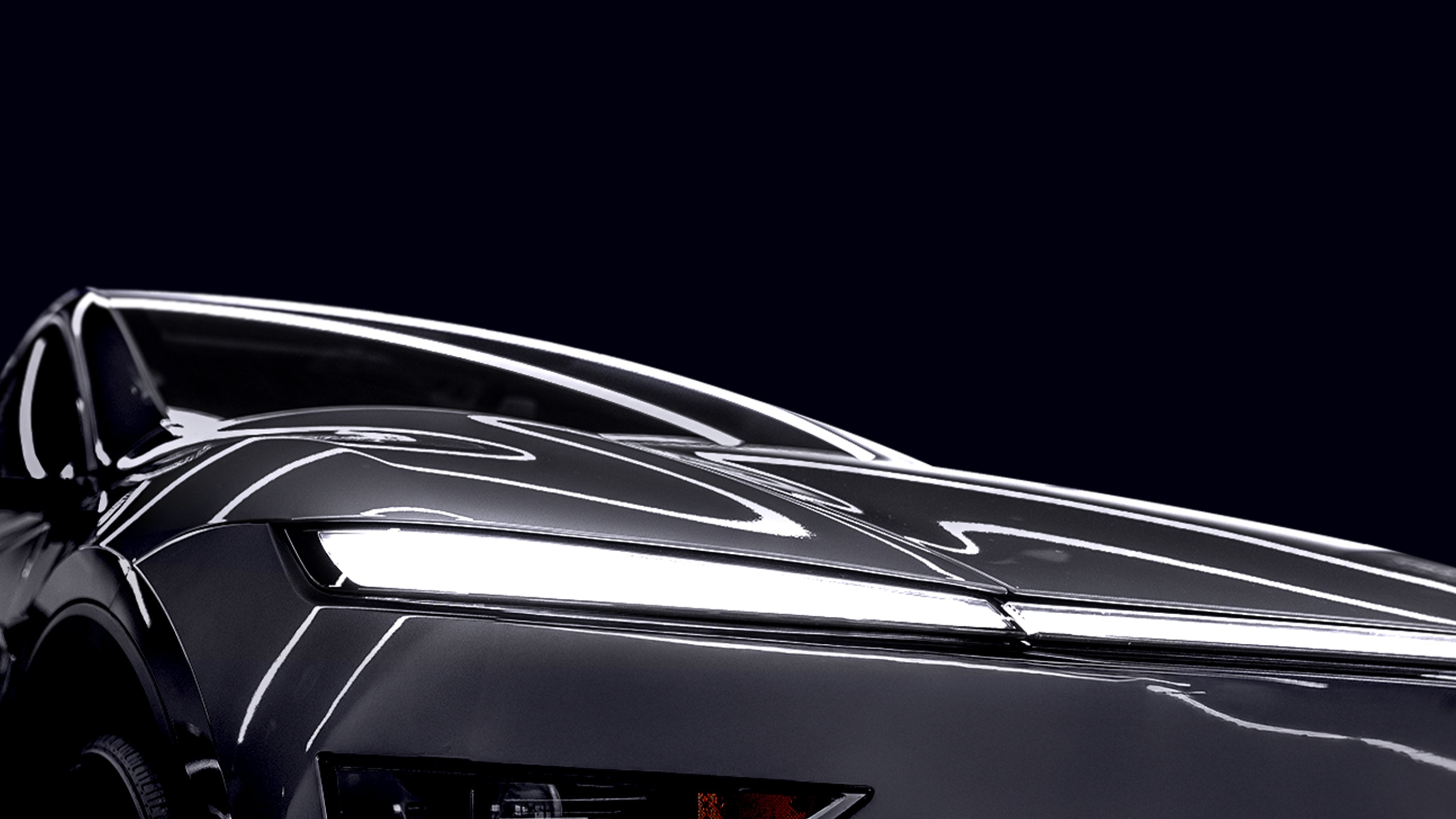 Showing the front corner of Tesla Model Y Juniper a dark grey color