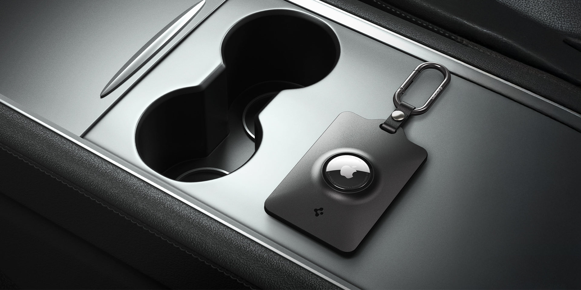 Spigen's tesla keycard airtag holder with carabiner shown on Tesla console