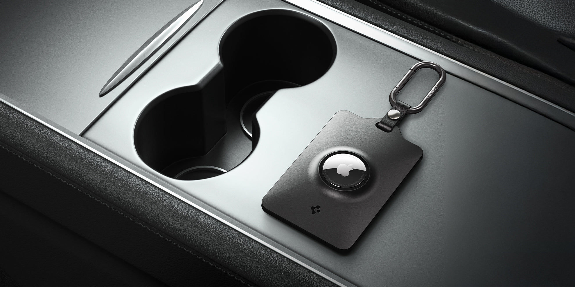 Spigen's tesla keycard airtag holder with carabiner shown on Tesla console
