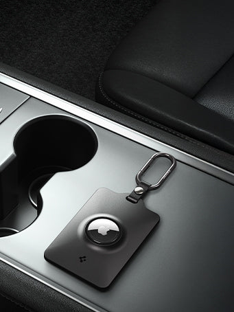 Spigen's tesla keycard airtag holder with carabiner shown on Tesla console