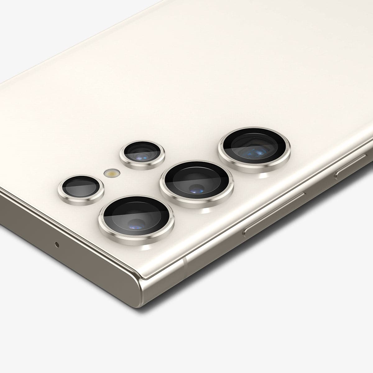 AGL06165 - Galaxy S23 Ultra EZ Fit Optik Pro Lens Protector in cream showing the device laying flat and zoomed in on camera lens