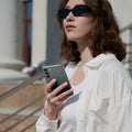 ACS06084 - Galaxy S23 Case Thin Fit in abyss green showing a woman outside with device in hand