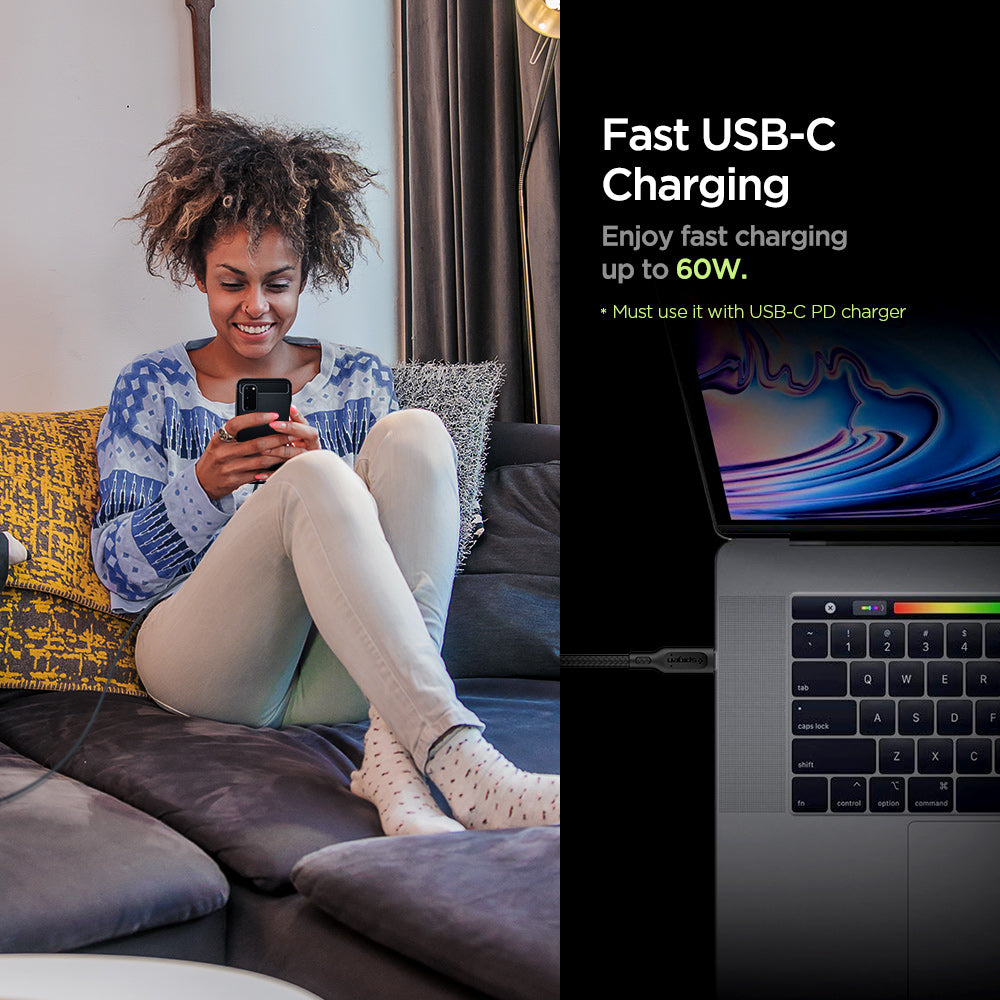 000CA25702 - DuraSync™ USB-C to USB-C 2.0 Cable C11C1 in Black showing the Fast USB-C Charging. Enjoy fast charging up to 60W. (Must use it with USB-C PD charger). A woman sitting while holding a device attached to a long wired charger and another device attached to a cable charger