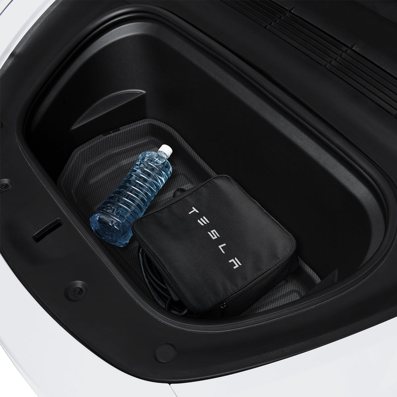 ACP06529 - Tesla Model Y Front Trunk Mat TL10-Y in Black showing the partial front installed in front of a car's trunk with water stuffs inside