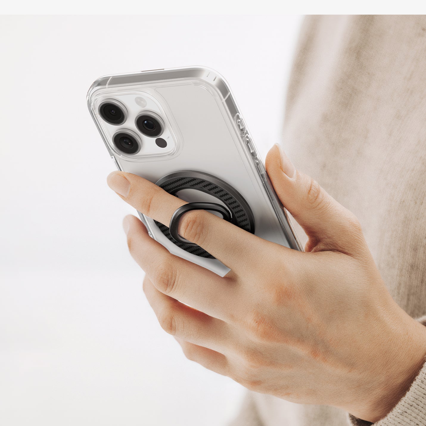 AMP09334 - O-Mag Magnetic Phone Holder (Mag Fit) | OM106 showing hand gripping clear iphone case with finger looped through extended black ring holder