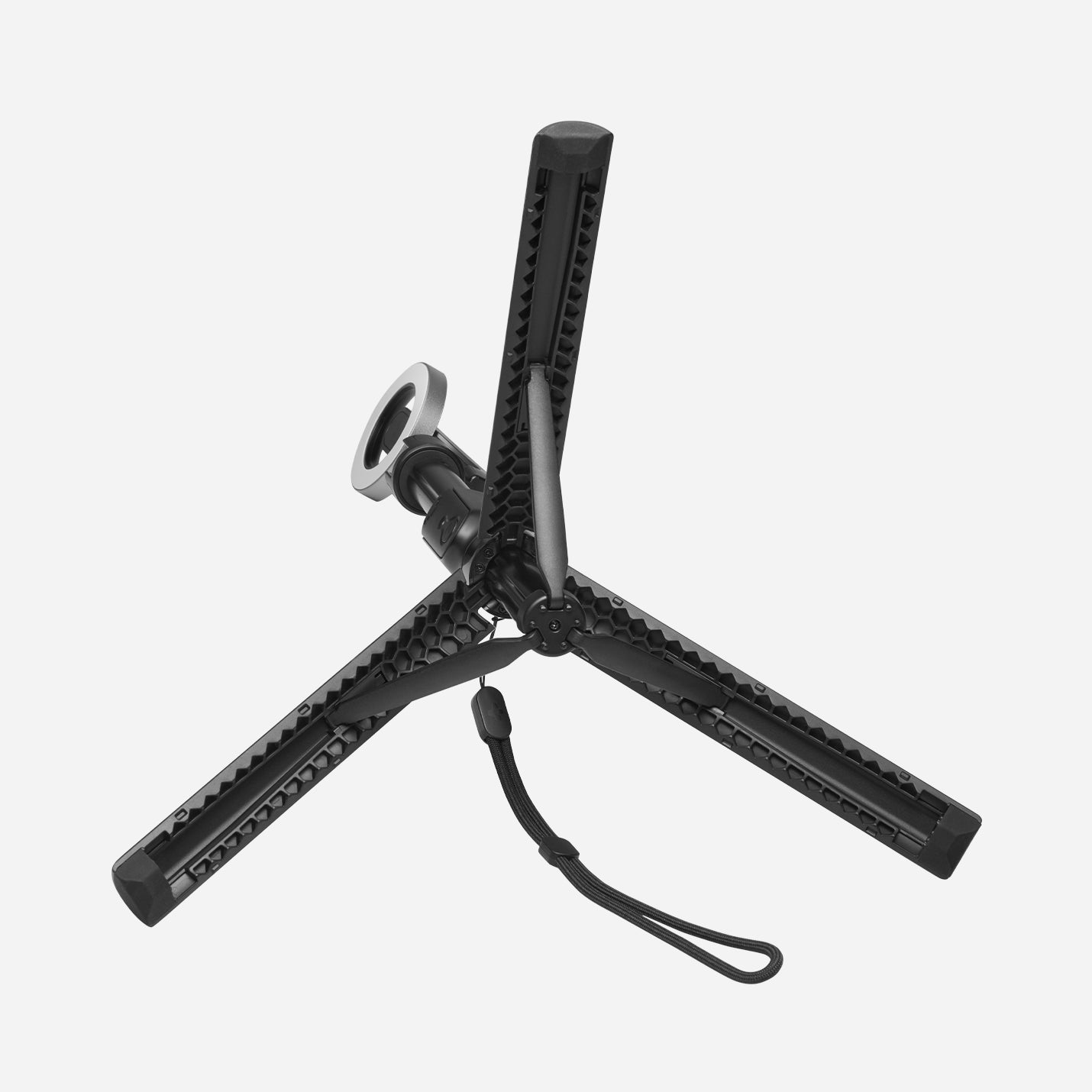 AMP07659 - Tripod Selfie Stick (Mag Fit) | S580W in Black showing the S580W tripod base with three honeycomb-textured legs fully extended and MagSafe mount head folded down, viewed from above against a light gray background.