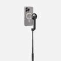 AMP07659 - Tripod Selfie Stick (Mag Fit) | S580W in Black showing an iPhone in a clear MagSafe case mounted to the S580W selfie stick in extended tripod mode, displayed against a light gray background.