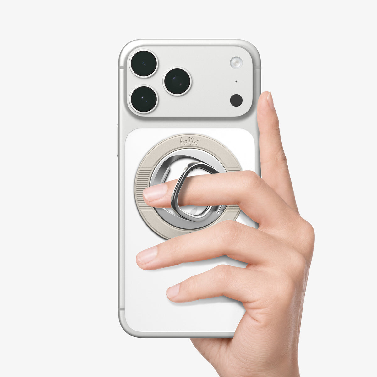AMP11738 - Hand holding a phone by slipping a finger through the Spigen Classic LS MagSafe ring attachment on the back