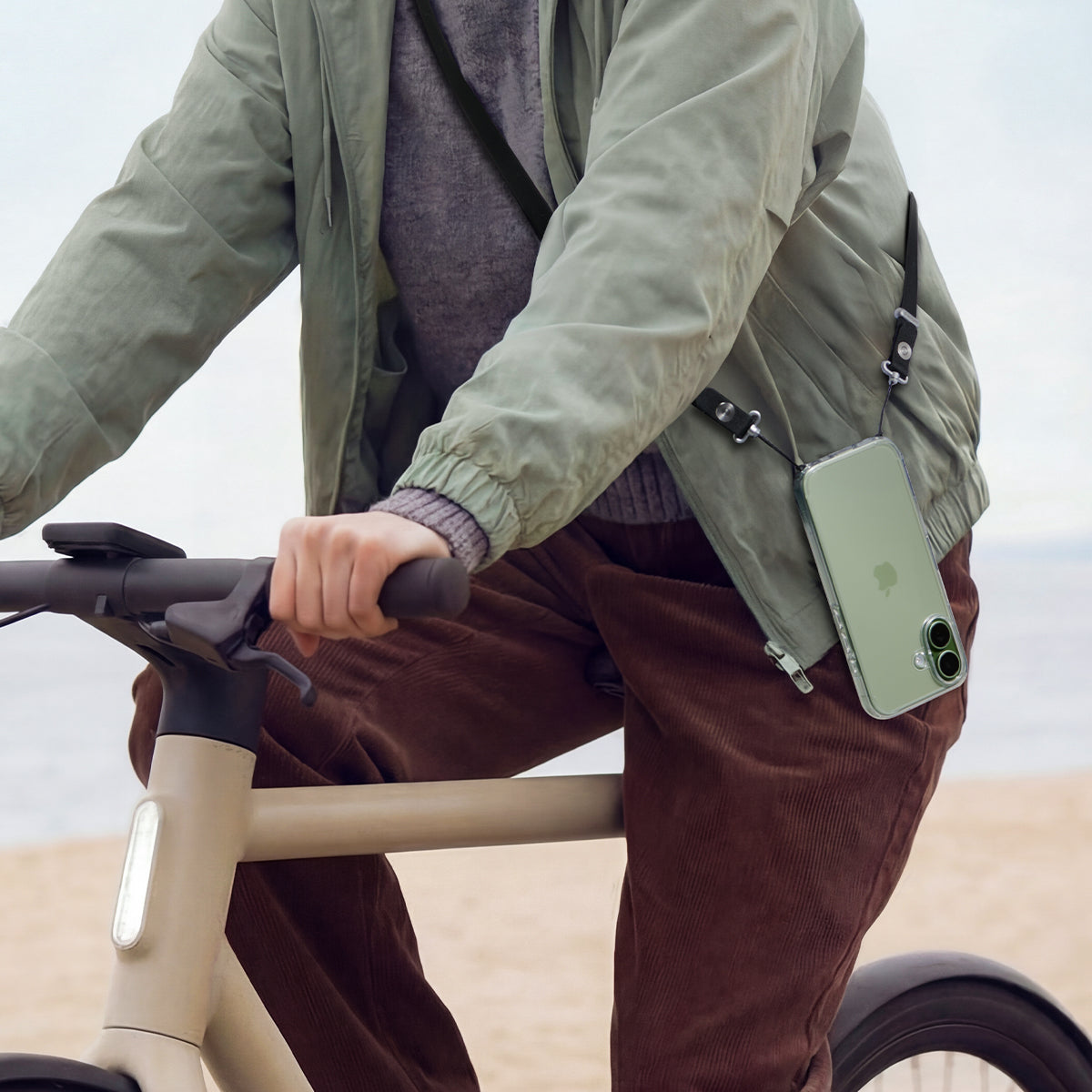 AFA10614 - Spigen Universal Phone Lanyard Strap showing secure phone carry during cycling