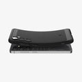 ACS08578 - Galaxy S24 FE Case Rugged Armor in Matte Black showing the back, partially  hovering above the device, top and bottom part, slightly lifted upward