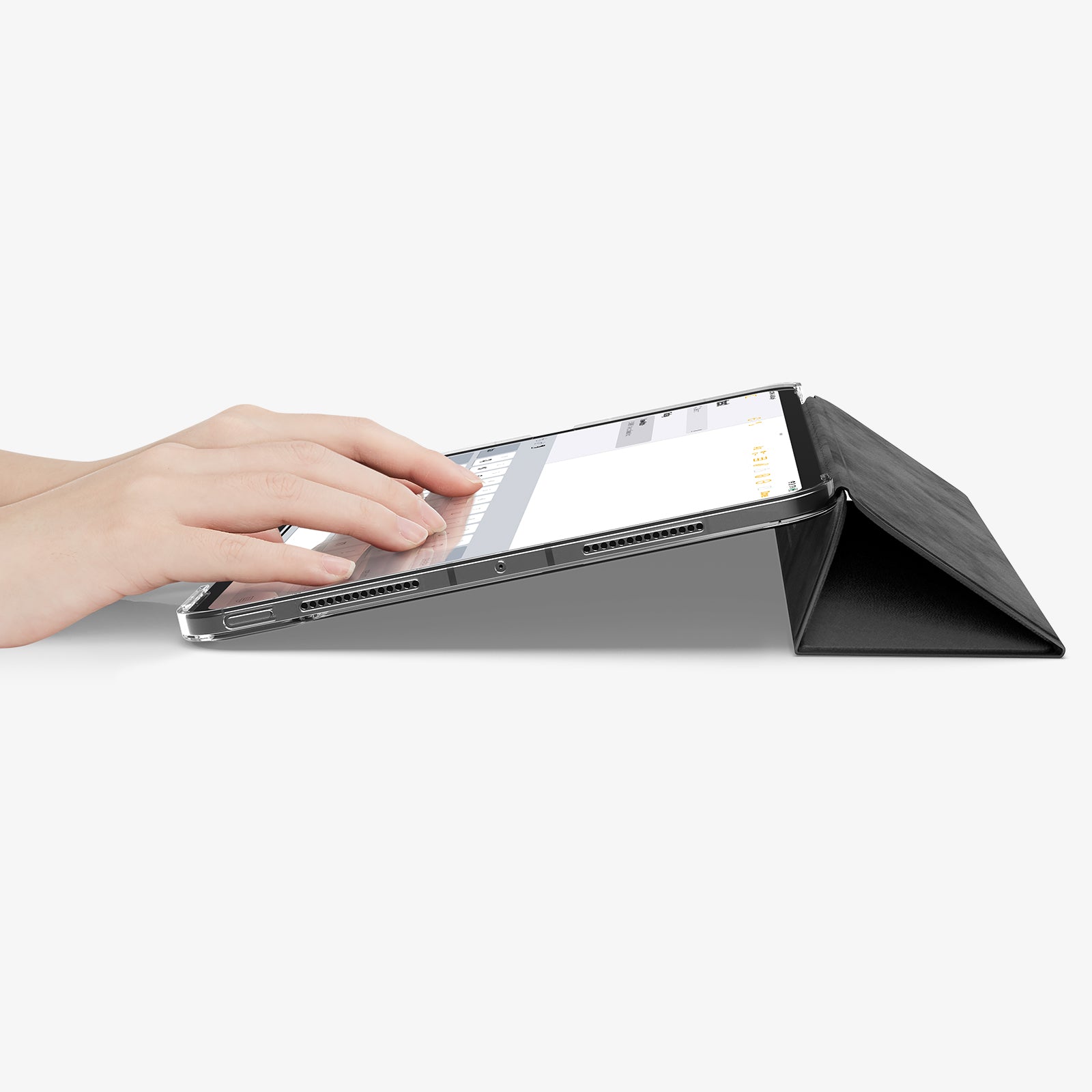 ACS09440 - iPad Pro 11-inch (2024) Case Liquid Air Folio in Black showing a person typing on the device while cover folded into a kickstand