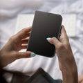 AGL12009 - iPhone Duo GLAS.tR EZ Fit Pro | Privacy showing a foldable device held in both hands with the screen protector installed over the display.