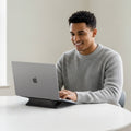 AMP10401 - Slim Fold Laptop Stand | LD201-S1 showing someone working on their laptop with stand propped up