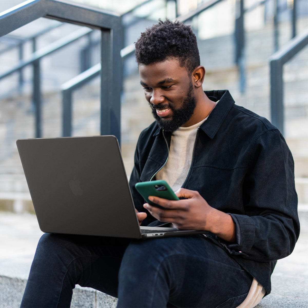 ACS11531 - MacBook Pro 13-inch Air Skin in Frost Black showing a person typing on a MacBook with the Frost Black case applied