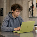 ACS11544 - MacBook Neo 13-inch Air Skin in citrus showing a person typing on a MacBook with the case applied