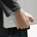 ACS11542 - MacBook Neo 13-inch Urban Fit in Heather Gray showing close up of case tucked under arm, logo detail visible