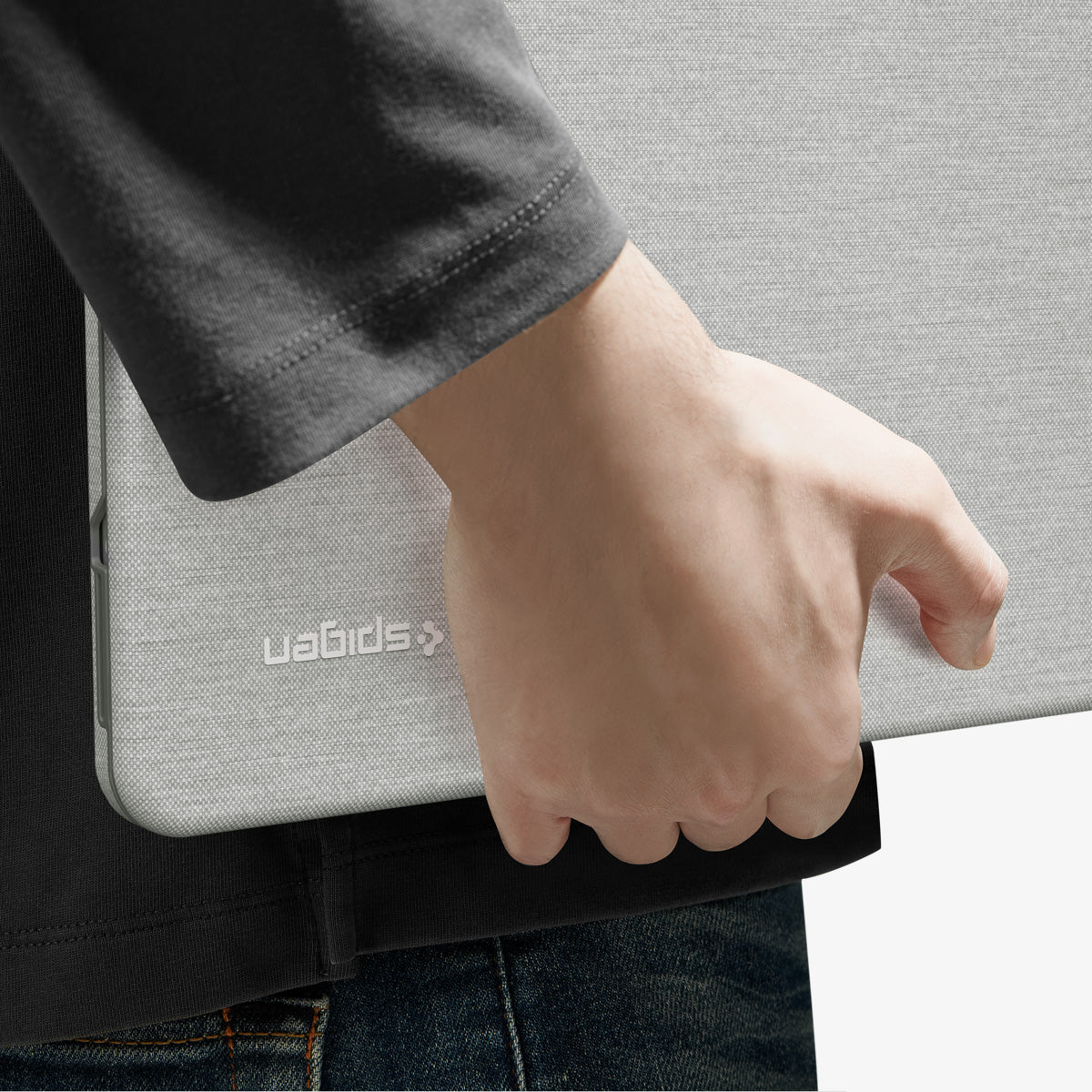 ACS11542 - MacBook Neo 13-inch Urban Fit in Heather Gray showing close up of case tucked under arm, logo detail visible