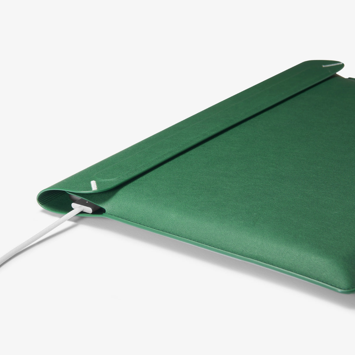 AFA06417 - MacBook Pro 14-inch Valentinus Laptop Pouch in JeJu Green side profile showing slim leather design with device inside and charger connected