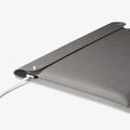 AFA06418 - Spigen Valentinus MacBook Sleeve side profile showing slim leather design with device inside and charger connected