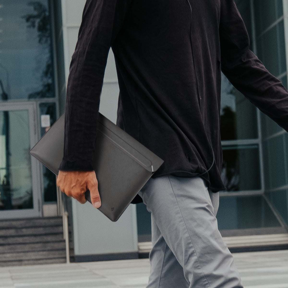 AFA06421 - Spigen Valentinus MacBook Sleeve being carried by hand outdoors