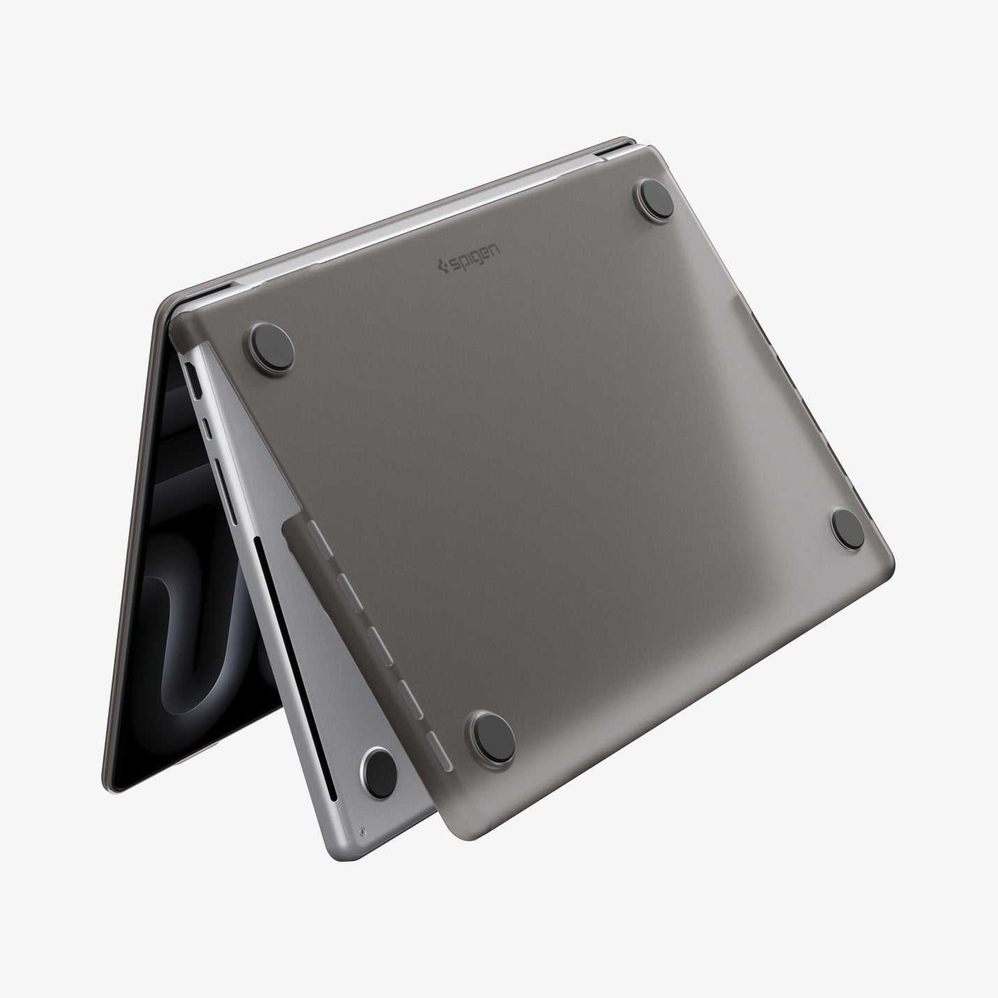 ACS11527 - MacBook Pro 16-inch Air Skin in Frost Black showing the bottom exterior with four rubber feet and the Spigen logo visible on a white background