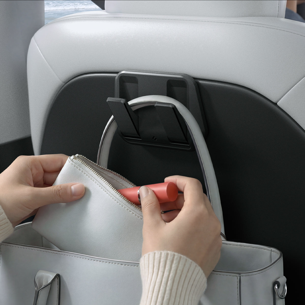 ACP11563 - Model Y Premium (2025+) in Black showing a seatback hook holding a handbag while allowing easy access to items inside.