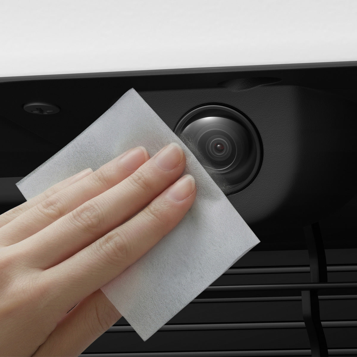 ACP11231 - Tesla Series - Front Camera Protector | TO331 showing a hand cleaning the front camera lens with a cloth to demonstrate easy maintenance.