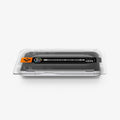 AGL11490 - Pixel 11 Pro Fold GLAS.tR EZ Fit Pro hand lowering the installation tray onto the phone with the dust removal tab extended for quick and precise screen protector installation.