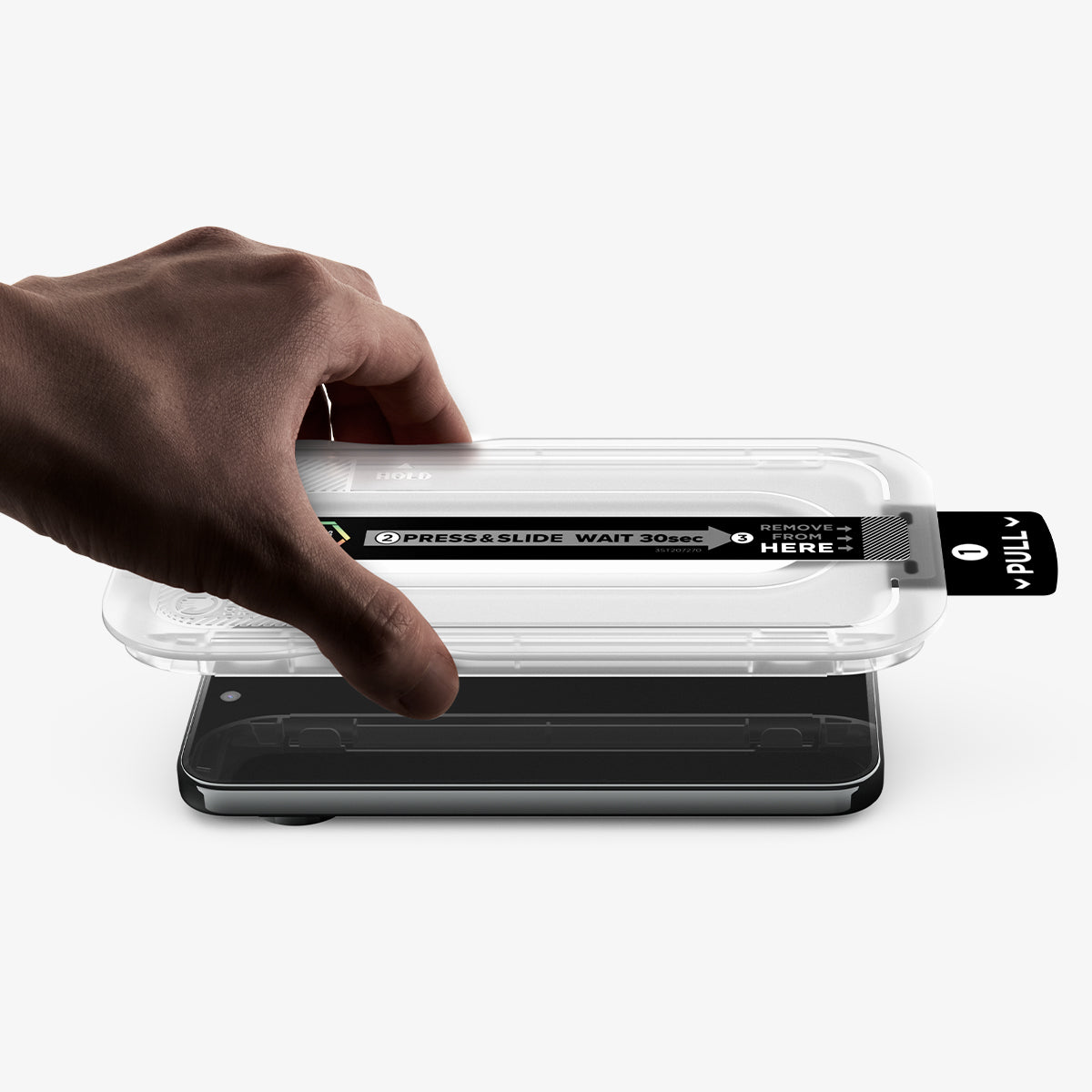 AGL11485 - Pixel 11 Pro XL GLAS.tR EZ Fit Pro hand lowering the installation tray onto the phone with the dust removal tab extended for quick and precise screen protector installation.