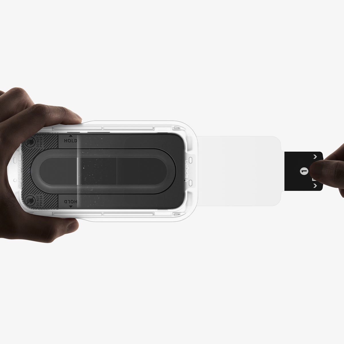 AGL11480 - Pixel 11 Pro  GLAS.tR EZ Fit Pro installation tray with the screen protector as the dust removal film is pulled through during the alignment process.