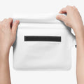 AMP06022 - AquaShield Waterproof Waist Bag (2 Pack) A620 in Snow White showing the first step in sealing the bag with its zip lock