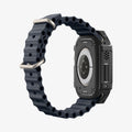 ACS11414 - Three-quarter back view of Spigen Rugged Armor Apple Watch Ultra case in matte black with carbon fiber side detail and black Band
