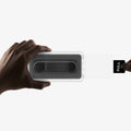AGL11397 - Hands demonstrating step two of Spigen EZ Fit Pro Galaxy A57 5G screen protector installation sliding glass out of tray