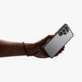 ACS11031 - Galaxy S26 Ultra Case Ultra Hybrid Space Crystal showing a hand with strap on with the device and case