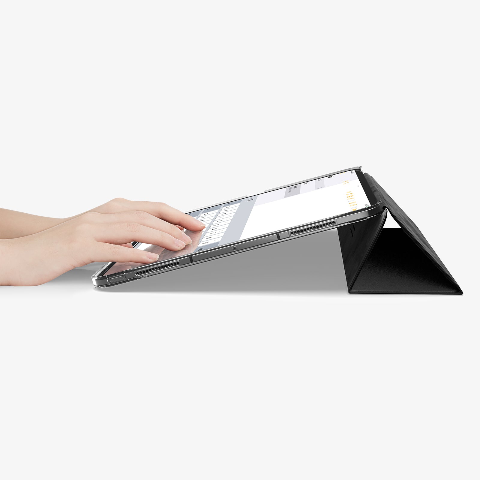 ACS09439 - iPad Pro 13-inch (2024) Case Liquid Air Folio in Black showing a person typing on the device while cover folded into a kickstand